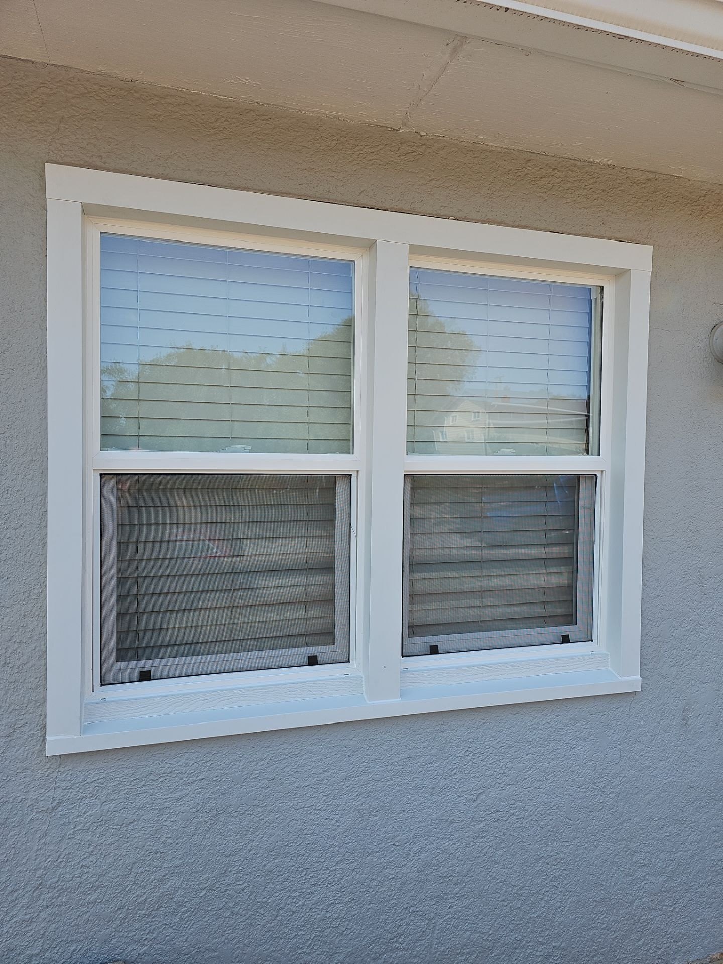 Finished double replacement windows with completed exterior trim